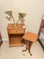 Nightstand, lamp and tripod table grouped together
