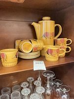 Full set on shelf showing pot, cups, saucers
