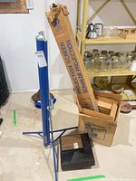 Slide projector in Sears box beside screen tube and stand