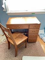 Sewing cabinet with chair front view