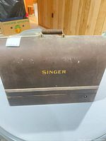Front view of closed Singer wooden case