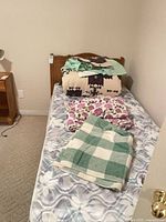 Overall view of twin bed setup with headboard, mattress, bedding