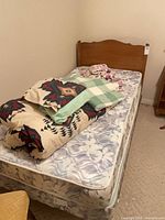 Single bed showing headboard, mattress, bedding