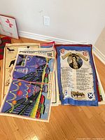 Stack of printed Scottish wall hangings on floor