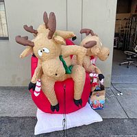 Full view of inflated reindeer decoration on pavement