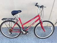Full left-side view of red Diamondback Sorrenic step-through bicycle showing frame, wheels, rack, drivetrain
