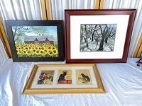 All three framed artworks: sunflower barn painting, winter orchard print, cat poster set