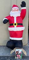Full view of inflated 8-foot Santa with box at base