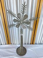 Full view of silver beaded snowflake tree topper standing upright