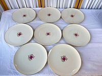 Eight Lenox Rosalyn dinner plates displayed front side