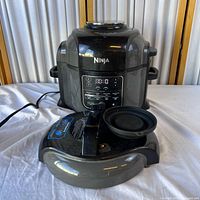 Full view of Ninja Foodi cooker with power cord and spare lid