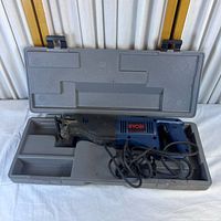 Full view of reciprocating saw in open case showing overall condition and included components