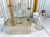 All items grouped: three cork bottles, swing-top bottle, stainless roaster with lid, enamel double boiler
