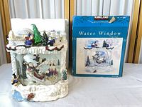 Front view of music box next to original box