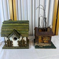 Both birdhouses side by side on table for size comparison