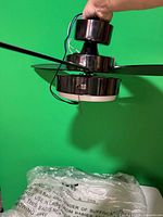 Side view showing motor housing, light kit, pull chain and wiring