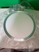 Front view of round LED ceiling light with frosted lens and silver trim