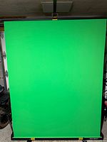 Green screen fully extended on stand showing fabric and support bar