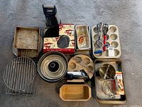 Overall view of all bakeware and tools spread on carpet