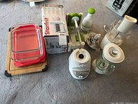 Lot overview showing all appliances, bakeware, cutting board