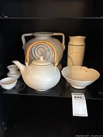 Shelf view showing all six cream ceramic items