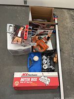 Group shot of all tools laid out including miter box, levels, jigsaw, hole saw kit, loose blades