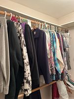 Assorted large-XXL shirts, jackets on closet rod