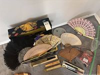 overview of assorted fans, boxes, feather fan, lace fan