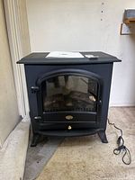 Front view of electric stove heater showing design and accessories on top