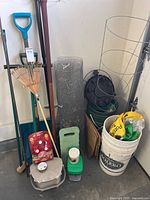 Wide view of all garden items leaning against wall