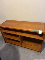 Front view of wood veneer media cabinet, closed position