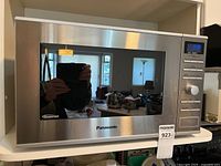 Front view of Panasonic stainless microwave showing brand and inverter marking