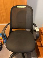 Front view of chair showing mesh back, seat, arms