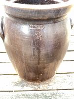 Front of brown crock showing H.B.&L. mark and handles