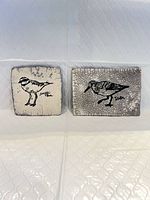 Both ceramic bird plaques side by side displaying size and finish