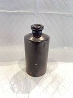 Front view of brown stoneware ink bottle