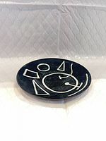 Front view of enamel plate showing abstract design