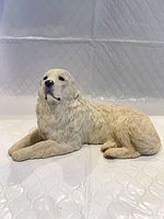 Full view of reclining Great Pyrenees sculpture right side