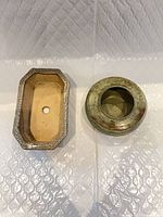 Two shallow ceramic planters side by side