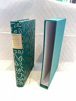 Book and slipcase standing upright