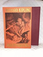 Front view of book inside slipcase showing cover illustration and titles