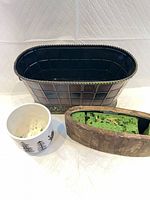 Group shot of three planters: metal, ceramic, wood