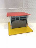 Front view of tin toy garage with door closed