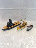 All three carved wooden boats group shot