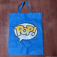 Front view of oversized blue Funko POP! tote bag with logo