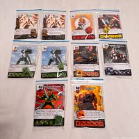 Overview of all nine bagged card-and-dice sets