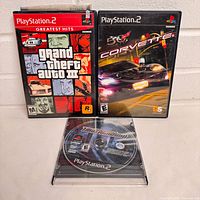 Front view of three PlayStation 2 games: GTA III, Corvette, Need for Speed Underground disc