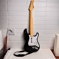 Full view of PlayStation Rock Band Fender Stratocaster guitar controller with strap