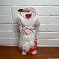 Front view of plush gnome holding envelope