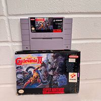 Front view of cartridge on top of box showing label and box art